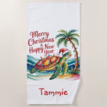 Christmas Turtle in Paradise  Beach Towel<br><div class="desc">A whimsical Christmas greeting card featuring a cheerful watercolor illustration of a sea turtle sporting a festive Santa hat and adorned with twinkling Christmas lights strung around its shell, set against a backdrop of a swaying palm tree also illuminated with warm lights and a serene turquoise ocean. The turtle's shell...</div>