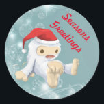 Christmas Yeti Doll Wearing a Santa Hat Classic Round Sticker<br><div class="desc">A sticker with an illustration of a cute little Christmas yeti, toy doll, wearing a red santa hat. The little yeti has a pull string to make him talk and he is covered in soft white fur with light brown accents. Background is a retro greenish blue colour with shining sparkling...</div>