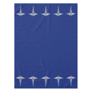 Chrome Like Caduceus Medical Symbol on Navy Blue Tablecloth