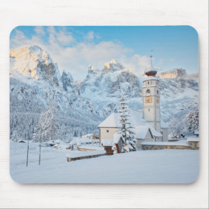 Church covered in snow with mountain background mouse pad