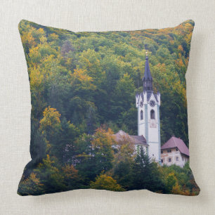 Church in a fall forest in Slovenia Cushion
