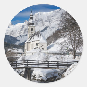 Church in the snow with Alps mountains Classic Round Sticker