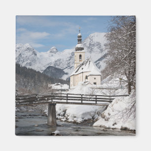 Church in the snow with Alps mountains in winter Magnet