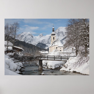 Church in the snow with Alps mountains in winter Poster