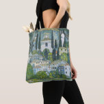 Church (Kirche) in Cassone by Gustav Klimt Tote Bag<br><div class="desc">Church in Cassone - Landscape with Cypresses (aka Kirche in Cassone - Landschaft mit Zypressen) (1913) by Gustav Klimt is a vintage Victorian Era Symbolism fine art painting featuring a church in the town of Cassone with surrounding stone buildings and cypress trees on the edge of Lake Garda in Italy....</div>