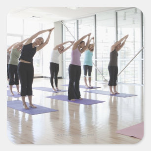class practicing yoga with instructor in a 2 square sticker