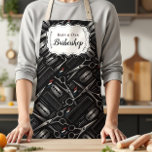 Classic Barbershop Tools Vintage Style Apron<br><div class="desc">A bold, classic barbershop design featuring illustrated grooming tools like scissors, razors, clippers, and combs arranged in a striking vintage composition. The deep charcoal background with subtle metallic tones creates a strong, masculine aesthetic inspired by traditional barber culture. An elegant ornamental label frame in the center keeps the layout clean...</div>