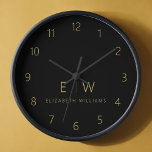 Classic Black Gold Minimalist Monogram Name<br><div class="desc">Enhance your home decor with our Classic Elegant Modern Minimalist Monogram Wall Clock. This exquisite timepiece seamlessly combines timeless elegance with contemporary minimalism, elevating your living space to new levels of sophistication. Crafted with precision and meticulous attention to detail, this wall clock is more than just a functional accessory; it's...</div>