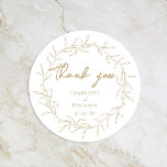 Classic Gold Greenery Wedding Thank You Classic Round Sticker<br><div class="desc">Introducing our Classic Gold Greenery Wedding Thank You Classic Round Sticker Design- meticulously designed to embody a modern romantic aesthetic. Featuring a classic blend of clean white backgrounds with delicate golden leaves gracefully complemented by a simple calligraphy script paired with an understated serif font. The result is a perfectly polished...</div>