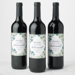 Classic White Flowers Bridesmaid Proposal Wine Label<br><div class="desc">This classic white flowers bridesmaid proposal wine label is perfect for a spring wedding. The elegant floral design features soft ivory and white roses, peonies, and chrysanthemum with touches of periwinkle blue watercolor flowers and green foliage. Customise the wine bottle label with the name of the bridesmaid, a short message...</div>