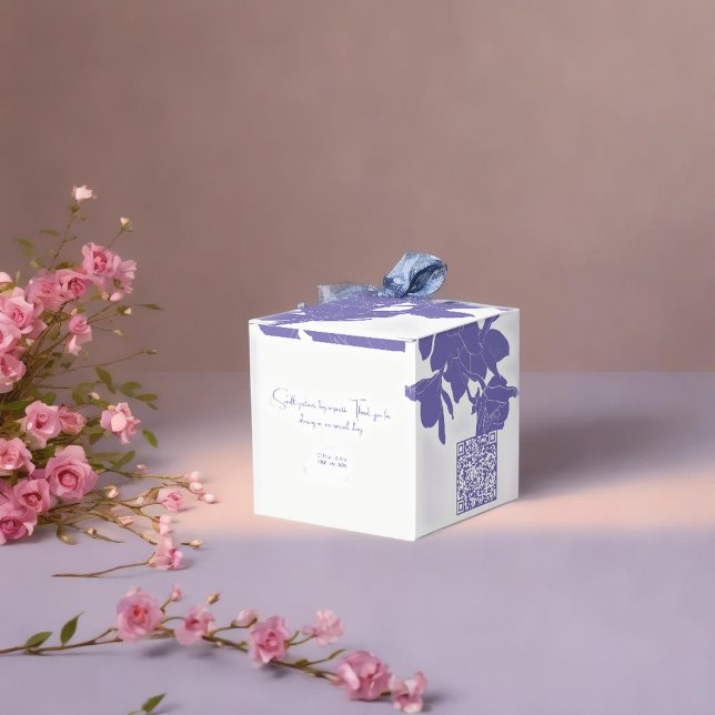 classy white & purple flowry  favour box (Luxury purple flowry favor boxes on soft surface next to pink flowers with warm up light )