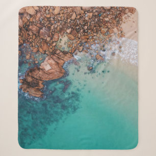 Clear blue sea and rocks sherpa blanket