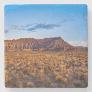 clear blue sky covers gorgeous brown hill stone coaster