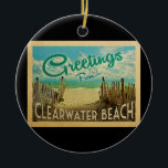 Clearwater Beach Vintage Travel Ceramic Tree Decoration<br><div class="desc">This Greetings From Clearwater Beach vintage postcard design features a sandy beach with a beautiful turquoise ocean water and above the sea,  a blue sky with billowy white clouds. In vintage travels style.</div>