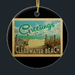 Clearwater Beach Vintage Travel Ceramic Tree Decoration<br><div class="desc">This Greetings From Clearwater Beach vintage postcard design features a sandy beach with a beautiful turquoise ocean water and above the sea,  a blue sky with billowy white clouds. In vintage travels style.</div>