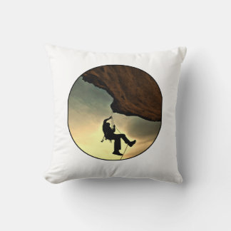 Climbing mountain man at sunset cushion