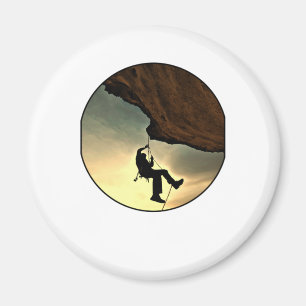 Climbing mountain man at sunset magnet