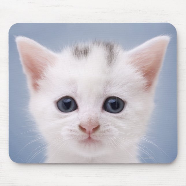 Close up image of a predominately white faced mouse pad (Front)