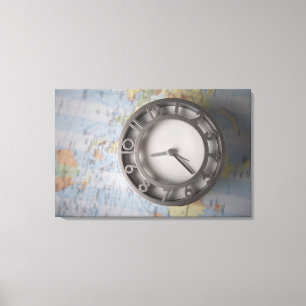 Close-up of a clock in front of a map canvas print