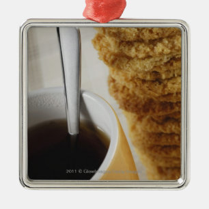 Close-up of a cup of coffee with cookies metal tree decoration