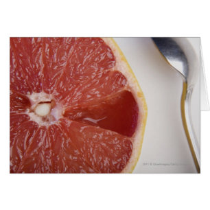 Close-up of a slice of orange and a spoon