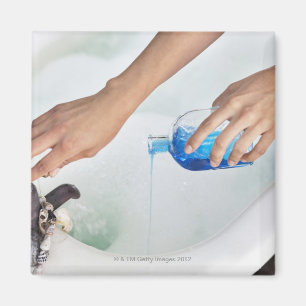 Close-up of a woman's hand pouring aromatherapy magnet