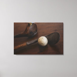 Close up of antique golf clubs and golf ball canvas print