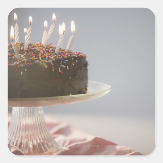 Close up of chocolate birthday cake with candles square sticker (Front)