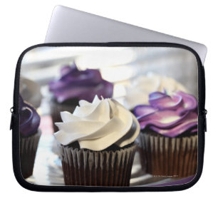 Close-up of cupcakes with selective focus on laptop sleeve