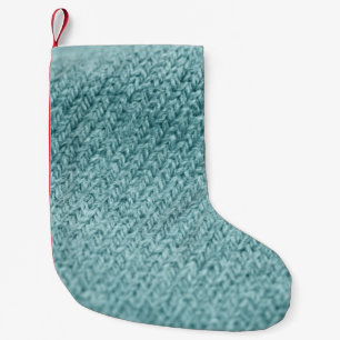 Close up of green knitted textured background. small christmas stocking