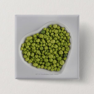 Close-up of green pebbles in a heart shape bowl 15 cm square badge