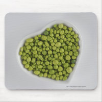 Close-up of green pebbles in a heart shape bowl