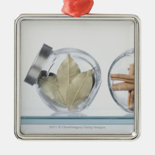 Close-up of herbs in two jars metal tree decoration