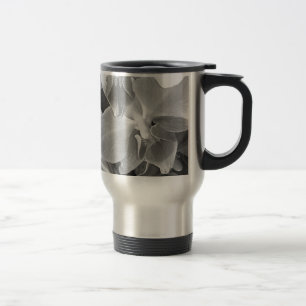 Close up of orchid blossoms in grey scale travel mug