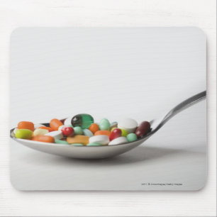 Close-up of pills in a spoon mouse pad
