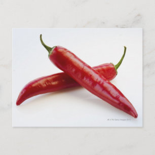 Close up of red chilli peppers on white postcard