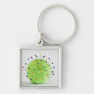 Close-up of straight pins inserted into a ball key ring