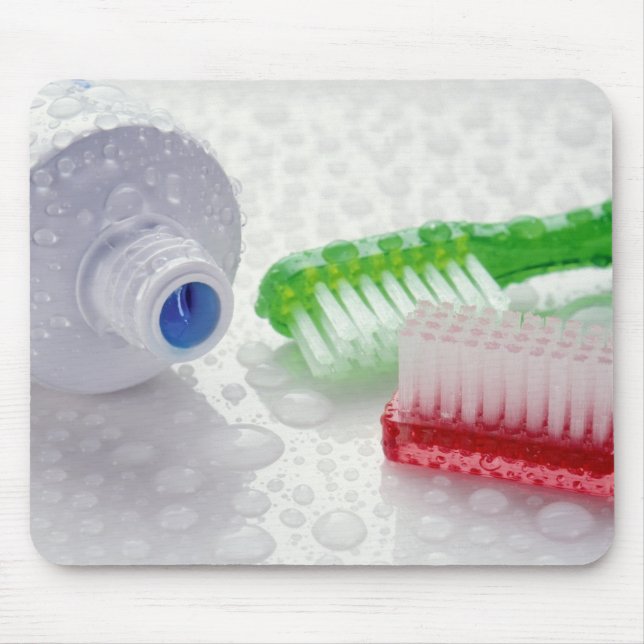 Close-up of toothpaste and toothbrushes covered mouse pad (Front)