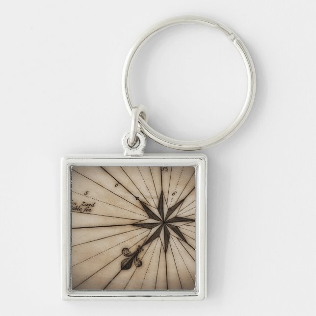 Close up of wind rose on antique map key ring (Front)