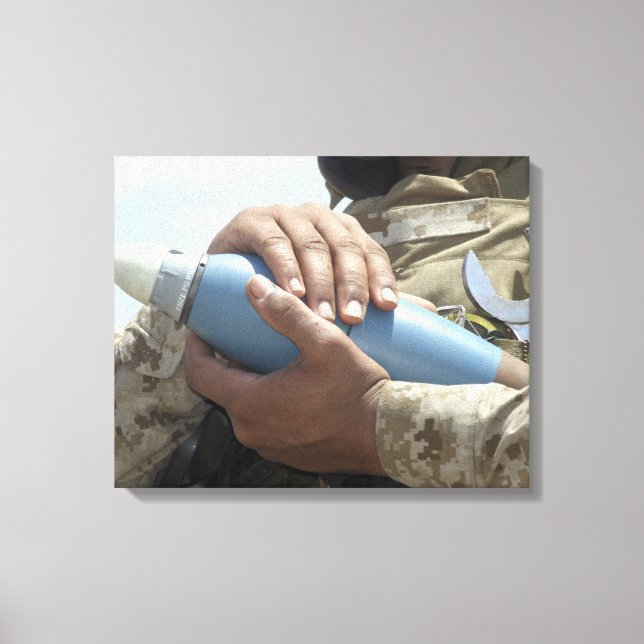 Close-up view of a soldier cradling a munition canvas print (Front)