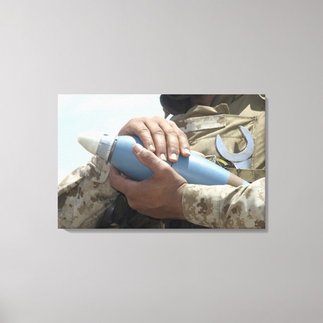 Close-up view of a soldier cradling a munition canvas print (Front)