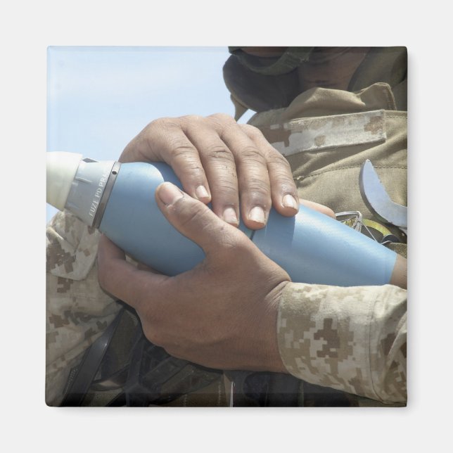 Close-up view of a soldier cradling a munition magnet (Front)