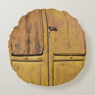 Closed brown wooden cabinet round cushion