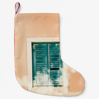 Closed green wooden door small christmas stocking