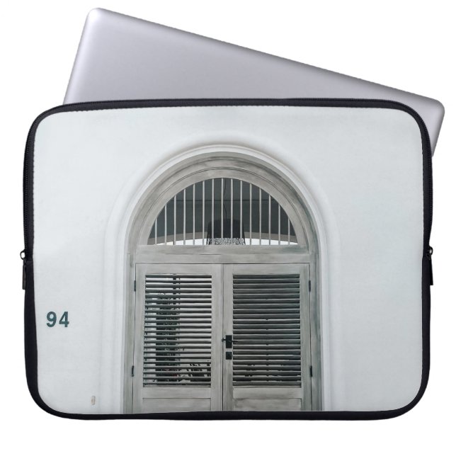 CLOSED GREY WOODEN DOOR BELOW BLACK LIGHT SCONCE LAPTOP SLEEVE (Front)