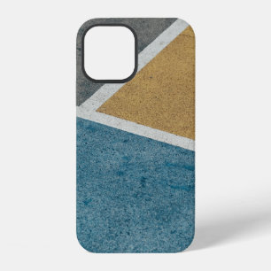 Closeup grey, yellow, and blue painted pavement iPhone 12 case