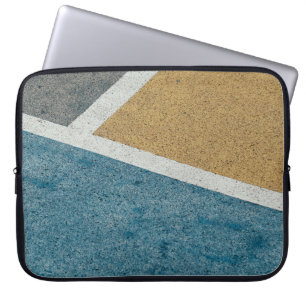 Closeup grey, yellow, and blue painted pavement laptop sleeve