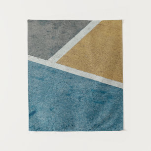 Closeup grey, yellow, and blue painted pavement tapestry