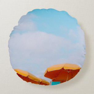 Closeup photo of lounger chairs and beach umbrella round cushion