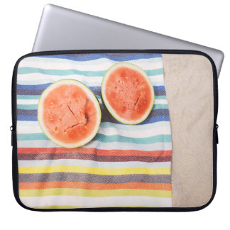 Closeup photo of slice watermelon fruits on cloth laptop sleeve